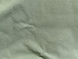 © warin - Closeup view empty light green natural clean fabric with Wrinkled background texture for design. Canvas texture. that can be used as wallpaper and backdrop for your item with copy space for text.