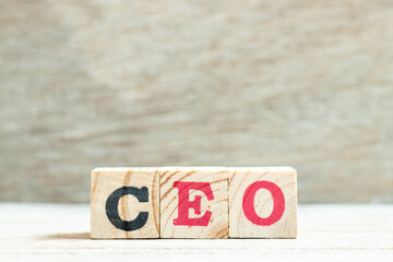 Wall Mural - Alphabet letter block in word CEO (Abbreviation of Chief Executive Officer) on wood background