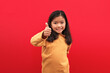 © estherpoon - Asian girl Thumb up on red background
