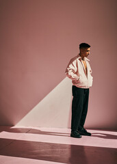 portrait of a man in a pink room