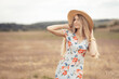 © Mikhail - A young woman in a hat in a meadow. Blonde in nature.