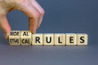 Ethical or moral rules symbol. Businessman turns wooden cubes and changes words 'ethical rules' to 'moral rules' on a beautiful grey background. Business, ethical or moral rules concept. Copy space.