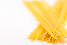 Isolated Shot Of Uncooked Spaghetti Noodles On A White Background