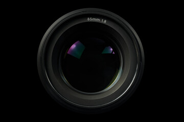 Top view of a professional optical lens for modern DSLR cameras isolated on a black background. High resolution image. 