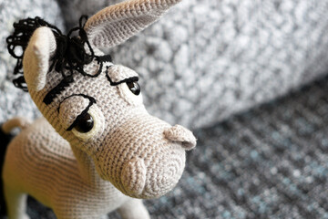 Wall Mural - Amigurumi doll is a gray donkey with big eyes.