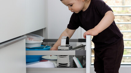 Child picking an item from storage hutch. Smart kitchen organization concept