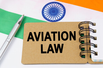 Against the background of the flag of India lies a notebook with the inscription - AVIATION LAW