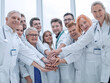 © ASDF - large group of doctors put their hands together.