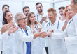 © ASDF - happy medical colleagues congratulating each other on their success.