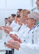 © ASDF - large group of medical practitioners applauding together.