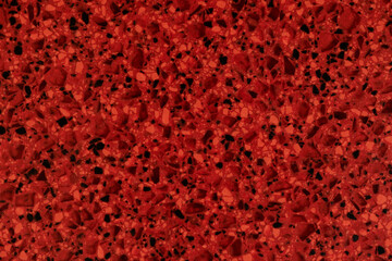 red pattern of artificial textured stone of tabletop for background. close up top view.