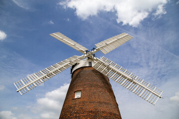 old windmill against a brilliant blue sky