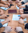 © ASDF - close up. the business team is making a circle of their hands over the desktop