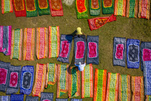 Aerial View Of People Working In A Public Laundry Draining And Drying Colourful Clothes At Sunlight, Araihazar, Dhaka Province, Bangladesh.