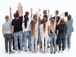 © ASDF - large team of young people pointing somewhere up .