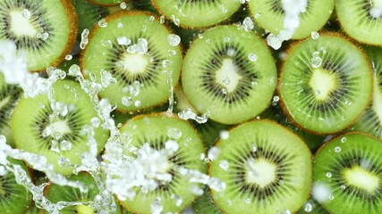 Poster - Super slow motion of kiwi slices with splashing water, top view. Filmed on high speed cinema camera, 1000 fps.