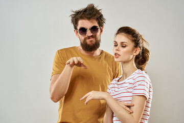 man in sunglasses next to woman in striped t-shirt emotions communication fashion studio fun