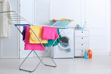 Clean Bright Laundry Hanging On Drying Rack Indoors