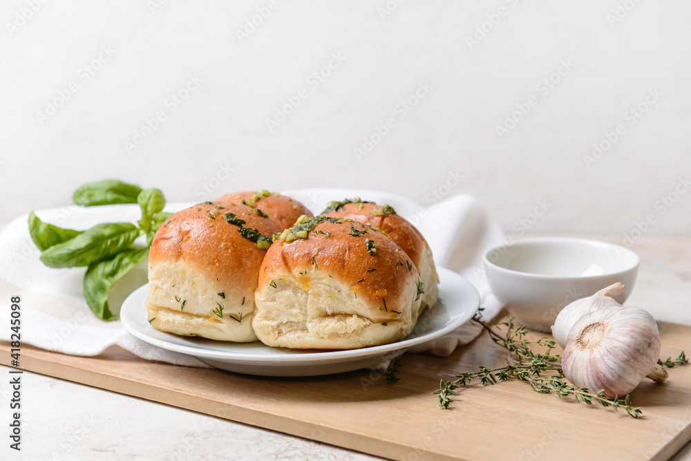 Fresh bread with different spices on light background