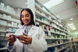 © StratfordProductions - Smiling young woman with medical tube wearing labcoat standing in chemist