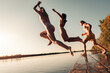 © Zoran Zeremski - Young friends having fun enjoying a summer day swimming and jumping at the lake.