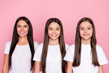 Wall Mural - Photo portrait of smiling happy mother and daughters wearing white t-shirts isolated pastel pink color background