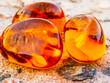 Round shape amber on stone surface.