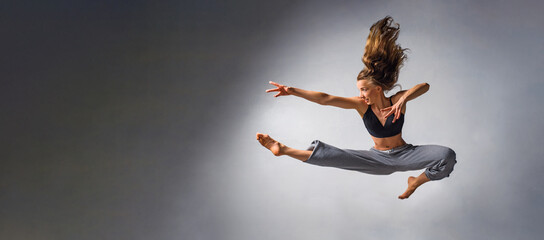 Urban happy girl dancing over isolated urban background and jumping