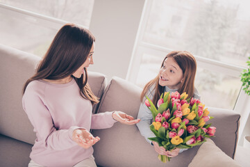 Wall Mural - Portrait of beautiful trendy cheerful girls daughter congratulating mum mommy good occasion at light house flat indoor