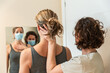Physiotherapist and patient in Global Postural correction session, with pandemic protection mask.