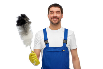 Wall Mural - profession, cleaning service and people concept - happy smiling male worker or cleaner in overall and gloves with duster over white background