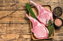 Fresh Raw Pork Loin Chops With Pepper And Salt. Wooden Background. Top View. Copy Space