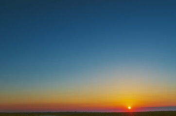 Poster - Stunning sunset with orange and blue clouds in dramatic sky