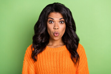 Poster - Photo of shocked charming lady look camera open mouth wear orange pullover isolated green background