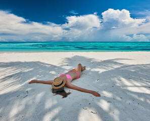 Wall Mural - Woman in bikini at tropical beach under the palm tree