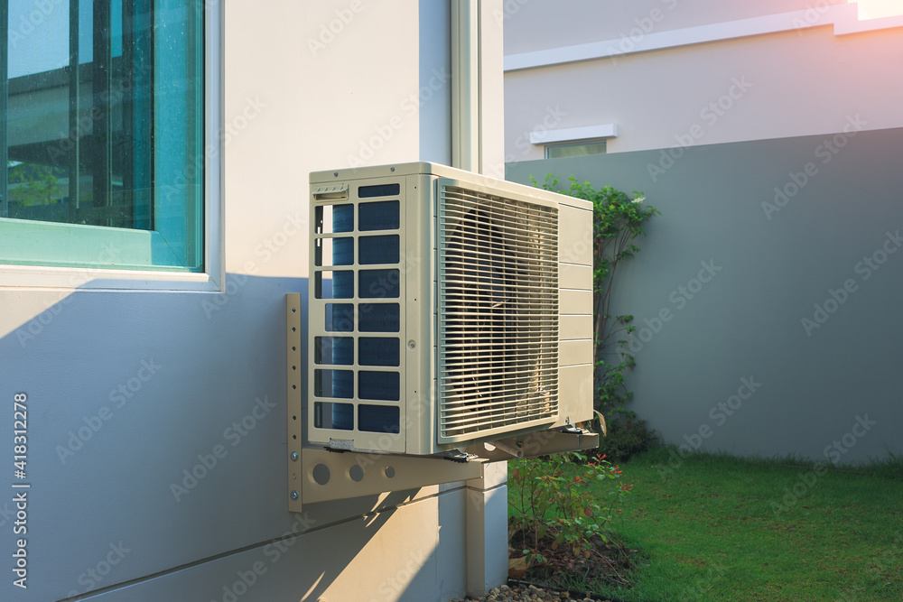 Condenser unit or compressor outside home or residential building. Unit ...