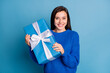 © deagreez - Photo of young attractive lovely happy positive girl smiling hold new year present isolated on blue color background