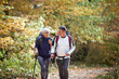 © luckybusiness - Elder couple hiking in forest