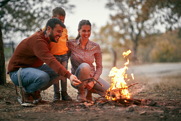 Happy family light fire in wood