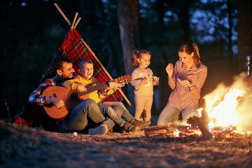 family enjoying with children on camping