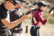 © guruXOX - Young people on tactical gun training classes. Shooting and Weapons. Outdoor Shooting Range