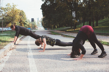 Three caucasian young man and women outdoor training