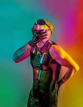 Multicolored Creative Artistic Portrait Of A Rubber Fetish, Latex Young Man With Fashion Leather Outfit On A Colorful Rainbow Lighting And Background.