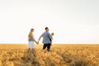 © Shopping King Louie - Happy family in wheat field at sunset having a great time together