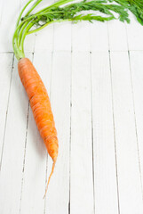 Poster - Carrot on white wooden table