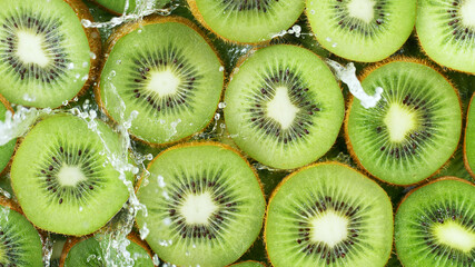 Wall Mural - Top view of sliced kiwi with water splashes