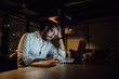 © Connect Images - Tired businessman in office at night typing on laptop