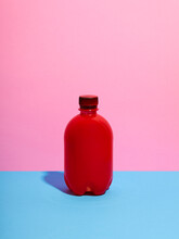 Still Life With Red Plastic Bottle And Pink Background