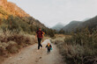 © Connect Images - Female toddler and young man walking along rural road, Mineral King, California, USA