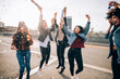 © Connect Images - Friends celebrating with confetti and soap bubbles in street, Milan, Italy